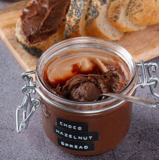 Jar of Chocolate Hazelnut Spread with sliced loaf of bread