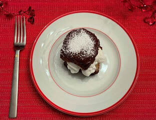 King's Hawaiian Dessert Puff topped with chocolate & confectioners' sugar and filled with whipped cream