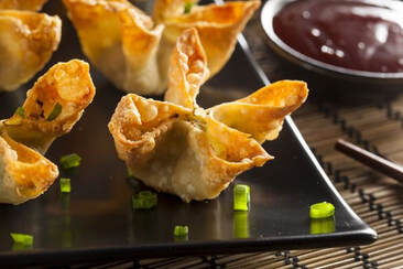 Crab Rangoon Wontons on plate with dipping sauce