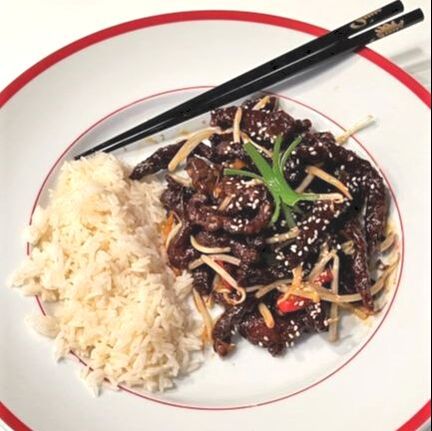 Plate of Twice Cooked Crispy Steak with rice and chopsticks