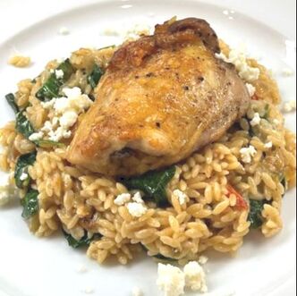 Plated Orzo with spinach and feta cheese and chicken thigh