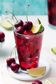Backyard Barbecue Bourbon-Cherry Fizzy Punch in a tall glass