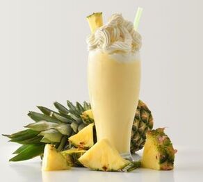 Pineapple Whipped Rum Cocktail with whole pineapple and pieces