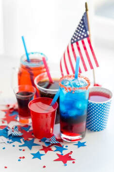Red White & Blue cups & beverages with US flag in background