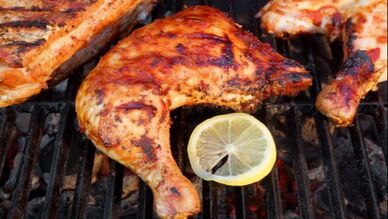 Chicken Quarters on the Grill with lemon slice