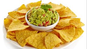 Bowl of Guacamole with chips surrounding