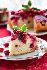 Cranberry Upside Down Cake Slice with Cake in the background